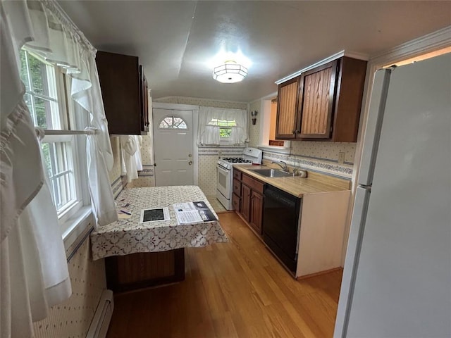 10689 Glenn Blvd, Conneaut Lake, PA 16316 - kitchen with freestanding refrigerator, black dishwasher, white gas range, light countertops, and light wood-style flooring