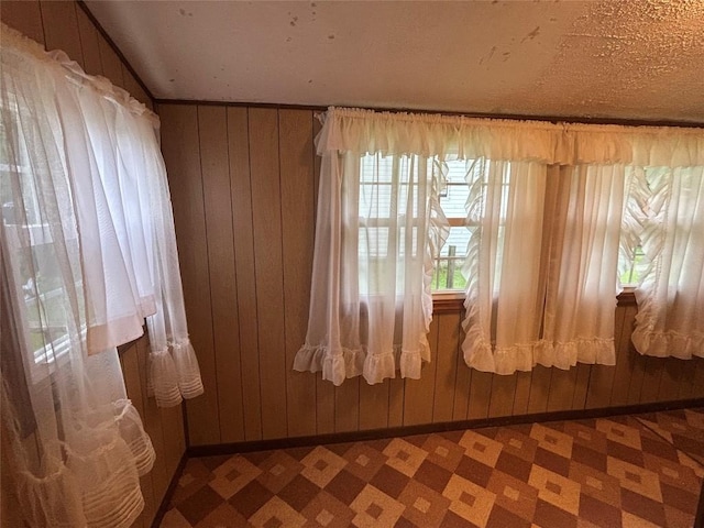 10689 Glenn Blvd, Conneaut Lake, PA 16316 - empty room featuring tile patterned floors and wooden walls