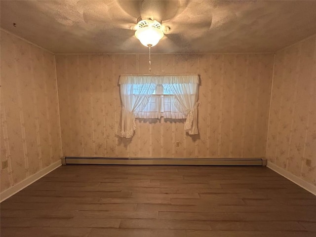 10689 Glenn Blvd, Conneaut Lake, PA 16316 - unfurnished room with dark wood-type flooring, baseboard heating, and a textured ceiling