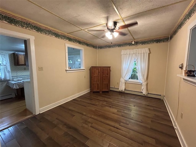 10689 Glenn Blvd, Conneaut Lake, PA 16316 - unfurnished bedroom with dark wood-type flooring, a baseboard radiator, a textured ceiling, a ceiling fan, and crown molding