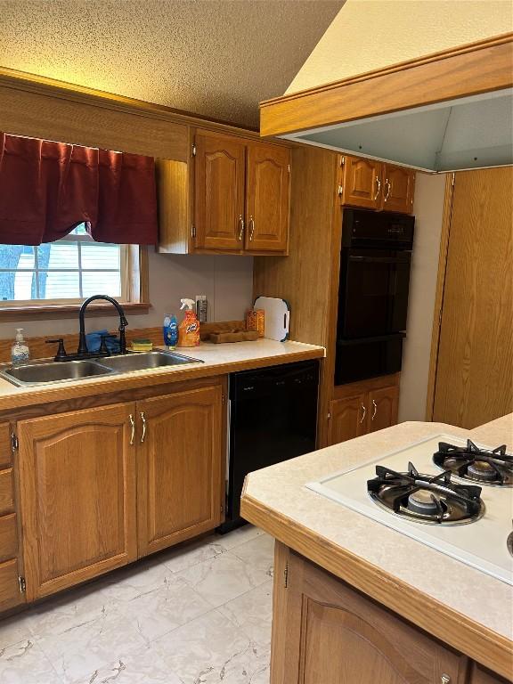 kitchen featuring a textured ceiling, white gas cooktop, extractor fan, sink, and black dishwasher