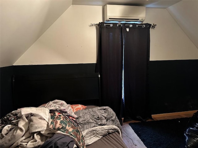 1048 W 6th St, Erie, PA 16507 - bedroom with an AC wall unit, lofted ceiling, and wood finished floors