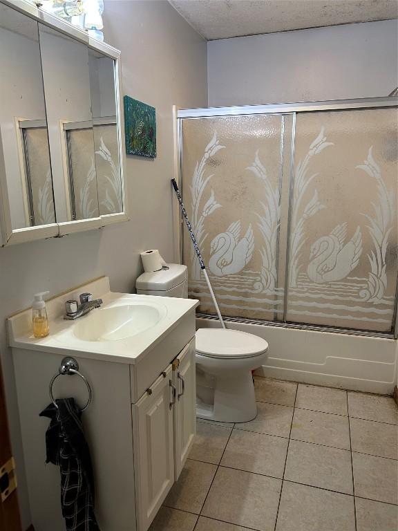1048 W 6th St, Erie, PA 16507 - bathroom featuring vanity, shower / bath combination with glass door, and tile patterned floors