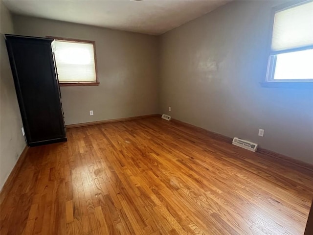 empty room with light hardwood / wood-style floors