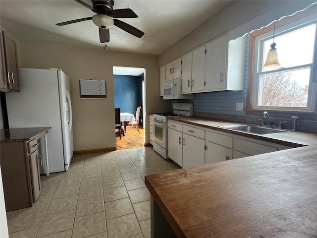 kitchen featuring white cabinetry, white appliances, sink, and pendant lighting