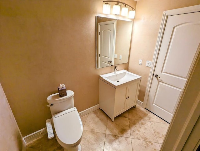 bathroom featuring tile patterned flooring, vanity, and toilet