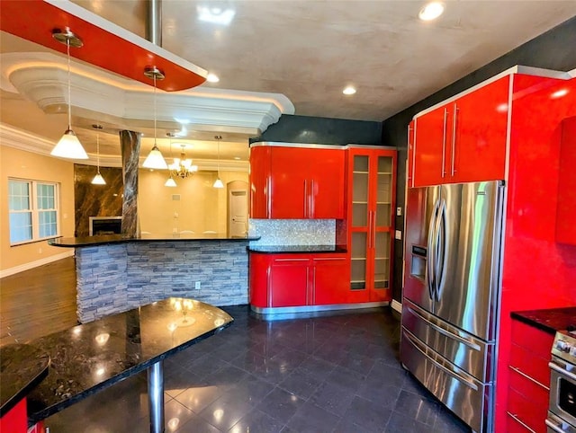 kitchen with crown molding, hanging light fixtures, a premium fireplace, tasteful backsplash, and stainless steel appliances