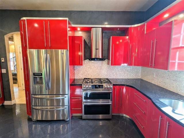 kitchen featuring backsplash, sink, stainless steel appliances, and wall chimney range hood