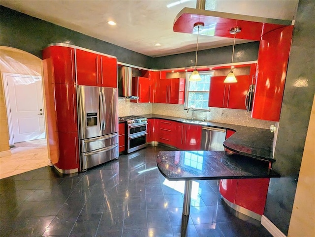 kitchen with wall chimney exhaust hood, sink, stainless steel appliances, and tasteful backsplash