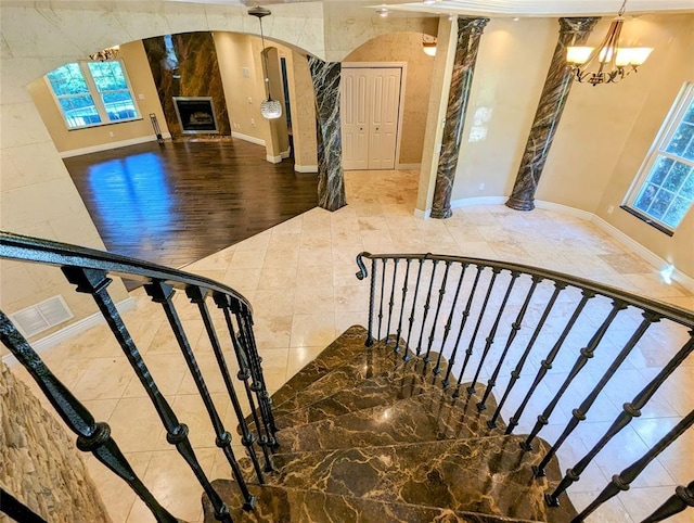 staircase featuring an inviting chandelier