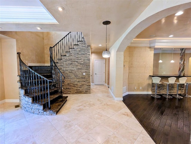 staircase featuring ornamental molding