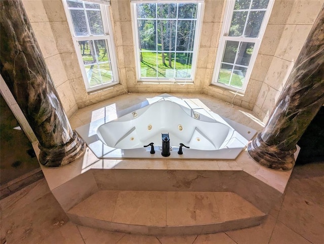 bathroom featuring tile patterned floors, tile walls, and tiled bath