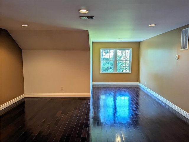 spare room featuring dark wood-type flooring