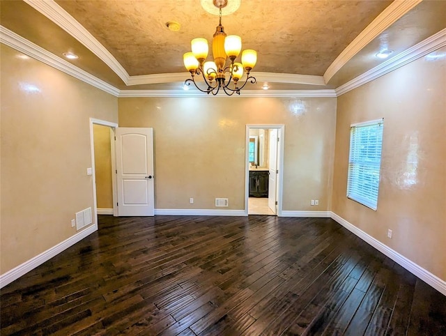 unfurnished room with a tray ceiling, crown molding, dark hardwood / wood-style floors, and an inviting chandelier