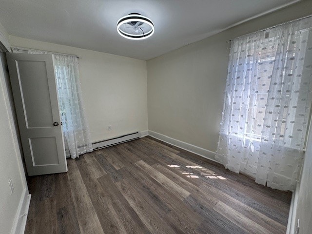 334 E 28th St, Erie, PA 16504 - unfurnished bedroom featuring a baseboard heating unit and wood finished floors