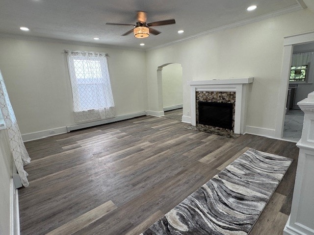 334 E 28th St, Erie, PA 16504 - unfurnished living room featuring a fireplace, ceiling fan, arched walkways, ornamental molding, and wood finished floors