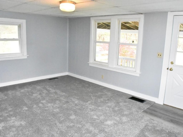 unfurnished room with dark carpet