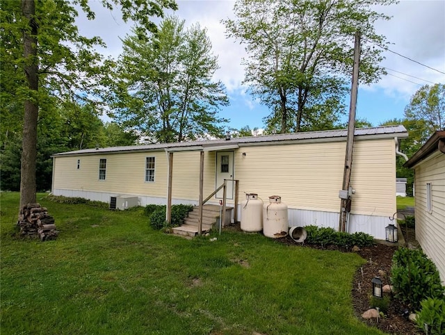 8734 Colonial Ln, Linesville, PA 16424 - back of house featuring a lawn and central air condition unit