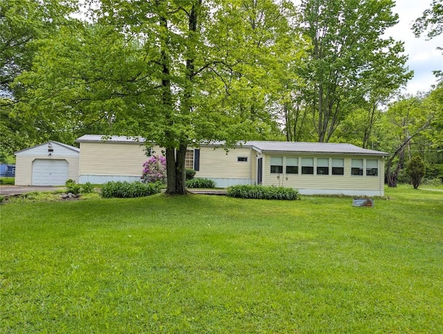 8734 Colonial Ln, Linesville, PA 16424 - manufactured / mobile home featuring an outdoor structure, a front lawn, a garage, and driveway