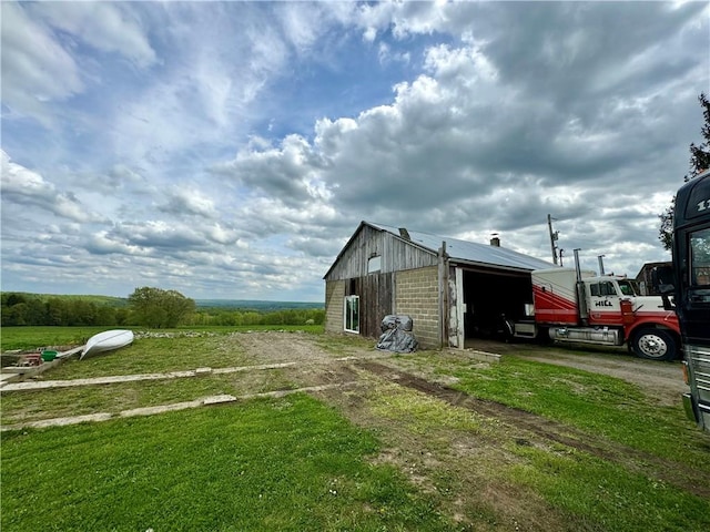 view of side of home featuring an outbuilding