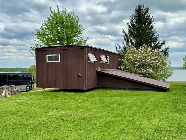 view of outbuilding with a lawn