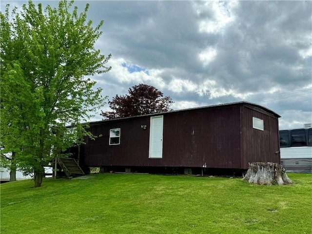 view of outbuilding with a lawn