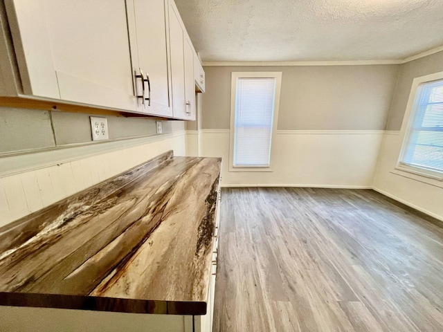 3624 Buffalo Rd, Erie, PA 16510 - kitchen with a textured ceiling, wood finished floors, white cabinetry, and crown molding