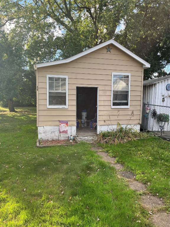 view of outbuilding with a yard