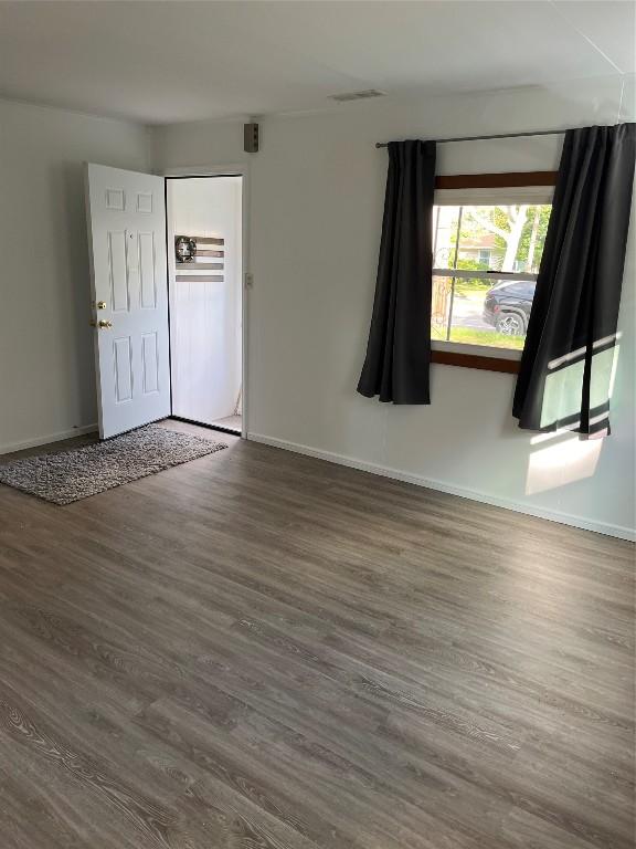 unfurnished room with dark hardwood / wood-style floors