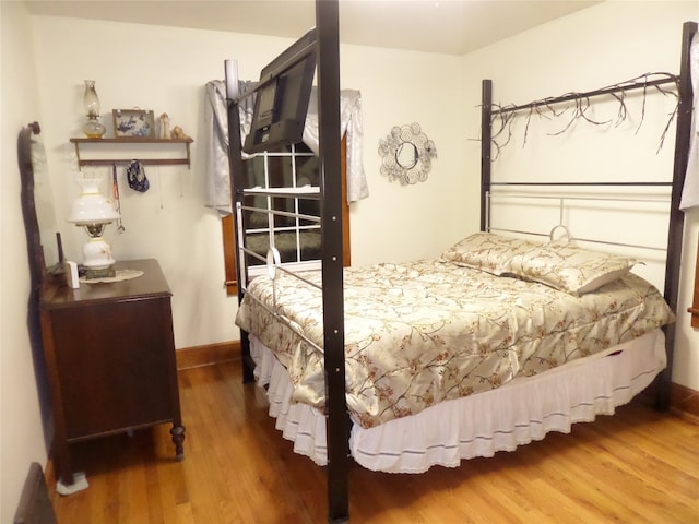 bedroom featuring dark hardwood / wood-style flooring