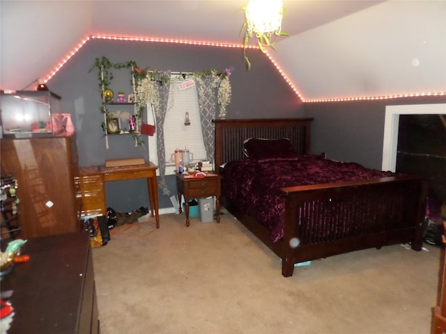 bedroom featuring carpet flooring, vaulted ceiling, and a notable chandelier