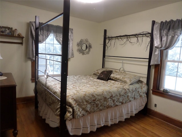 bedroom with dark hardwood / wood-style floors