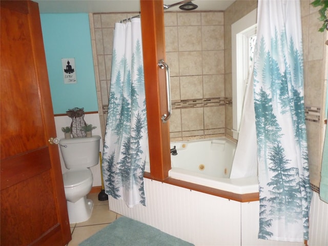 bathroom with tile walls, shower / bath combination with curtain, tile patterned floors, and toilet