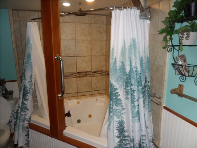 bathroom with shower / bath combination with curtain and toilet