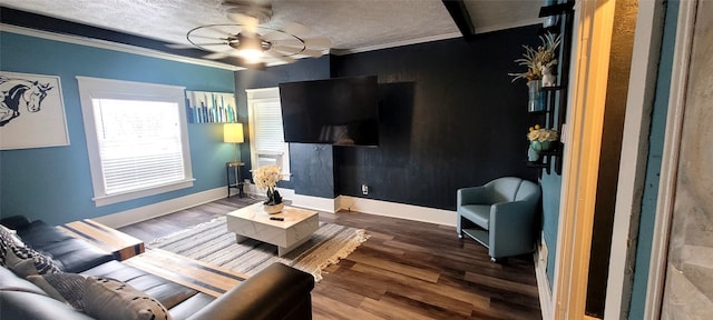 living room featuring a textured ceiling, ceiling fan, ornamental molding, and hardwood / wood-style floors