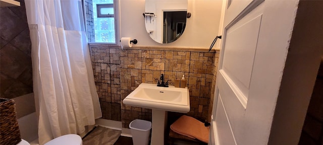 bathroom featuring sink, tile walls, and walk in shower