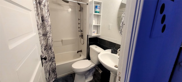 full bathroom with sink, toilet, and shower / bath combination with curtain