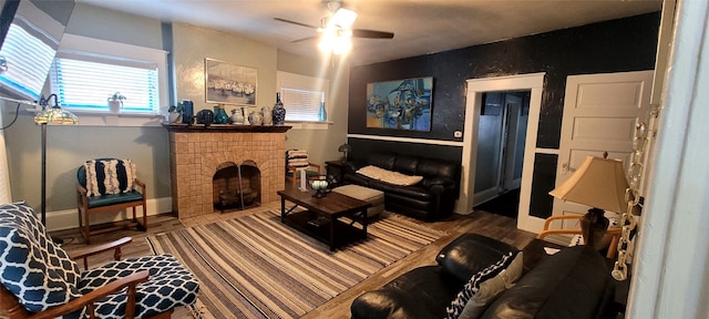 living area featuring ceiling fan, a fireplace, and hardwood / wood-style floors