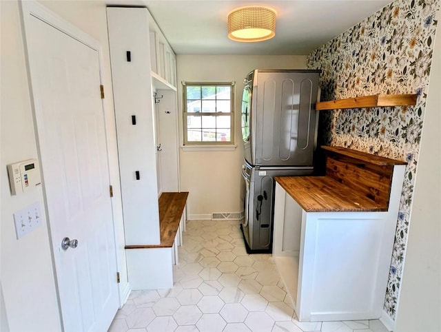 732 Walbridge Rd, Erie, PA 16511 - laundry area with estacked washer and dryer and light tile patterned floors