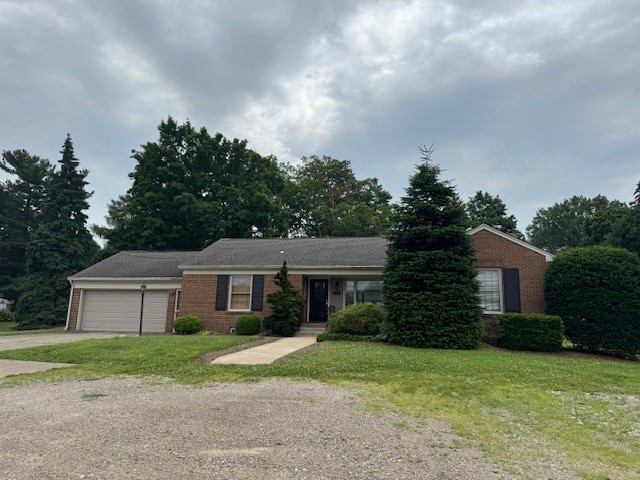 3233 W 26th St, Millcreek, PA 16505 - ranch-style home with driveway, a garage, a front yard, and brick siding