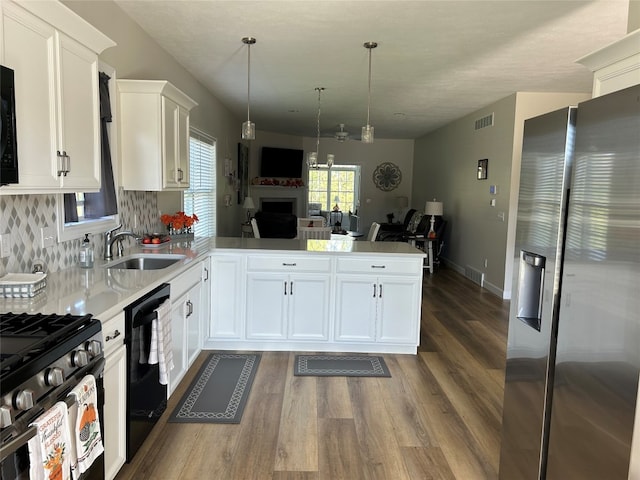 kitchen with white cabinetry, sink, kitchen peninsula, and stainless steel appliances