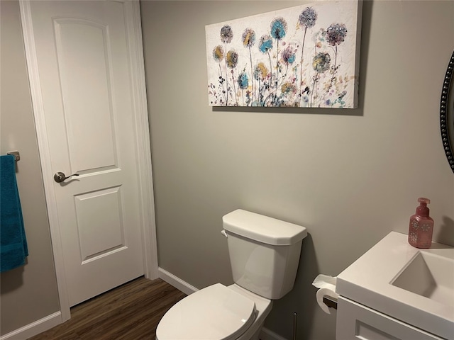 bathroom featuring toilet, hardwood / wood-style floors, and sink