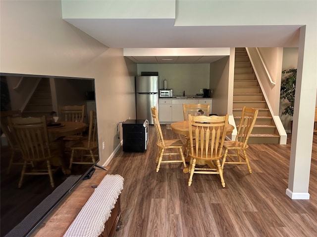 dining room with dark hardwood / wood-style flooring