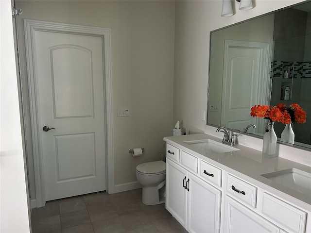 bathroom featuring toilet, vanity, and tile patterned floors