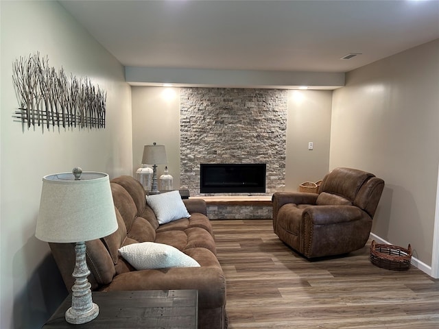 living room with a fireplace and hardwood / wood-style flooring