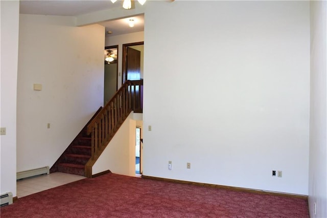 unfurnished living room featuring a baseboard heating unit, carpet, and ceiling fan