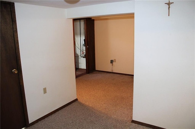 corridor featuring carpet and baseboards