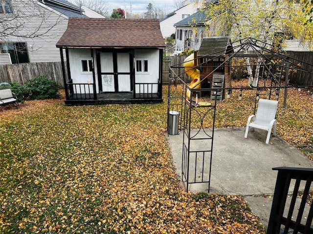 view of yard featuring an outbuilding, a gazebo, and a patio