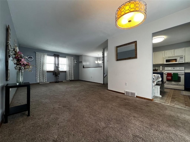 carpeted living room featuring a notable chandelier