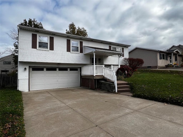 bi-level home with a front yard and a garage